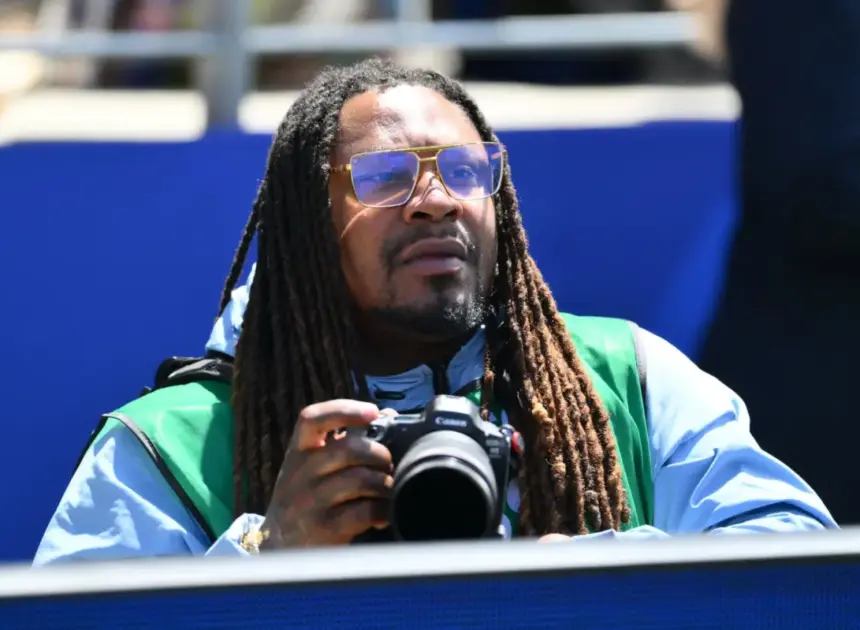 Marshawn Lynch works as photographer for USA vs Australia match