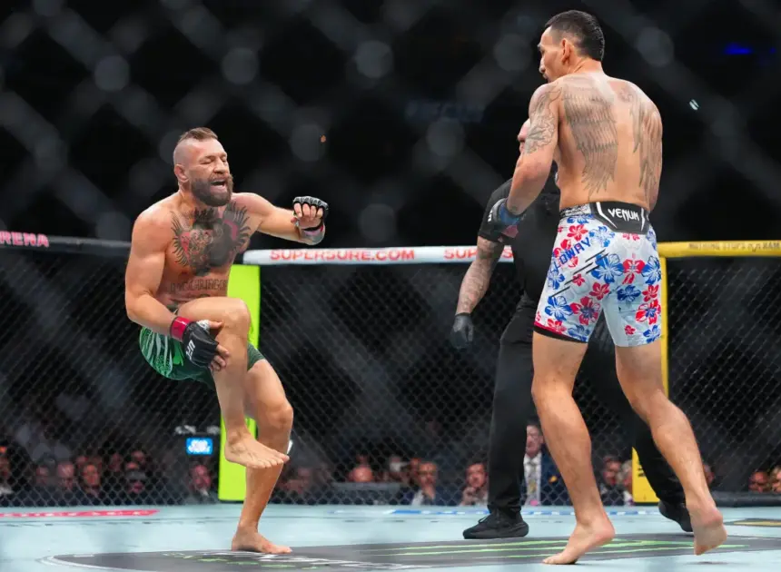 Conor McGregor injures leg seconds into fight in loss to Max Holloway — and is heavily booed by UFC 329 fans