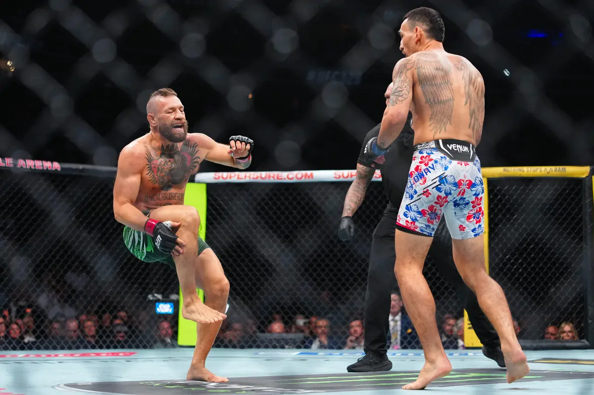 Conor McGregor injures leg seconds into fight in loss to Max Holloway — and is heavily booed by UFC 329 fans